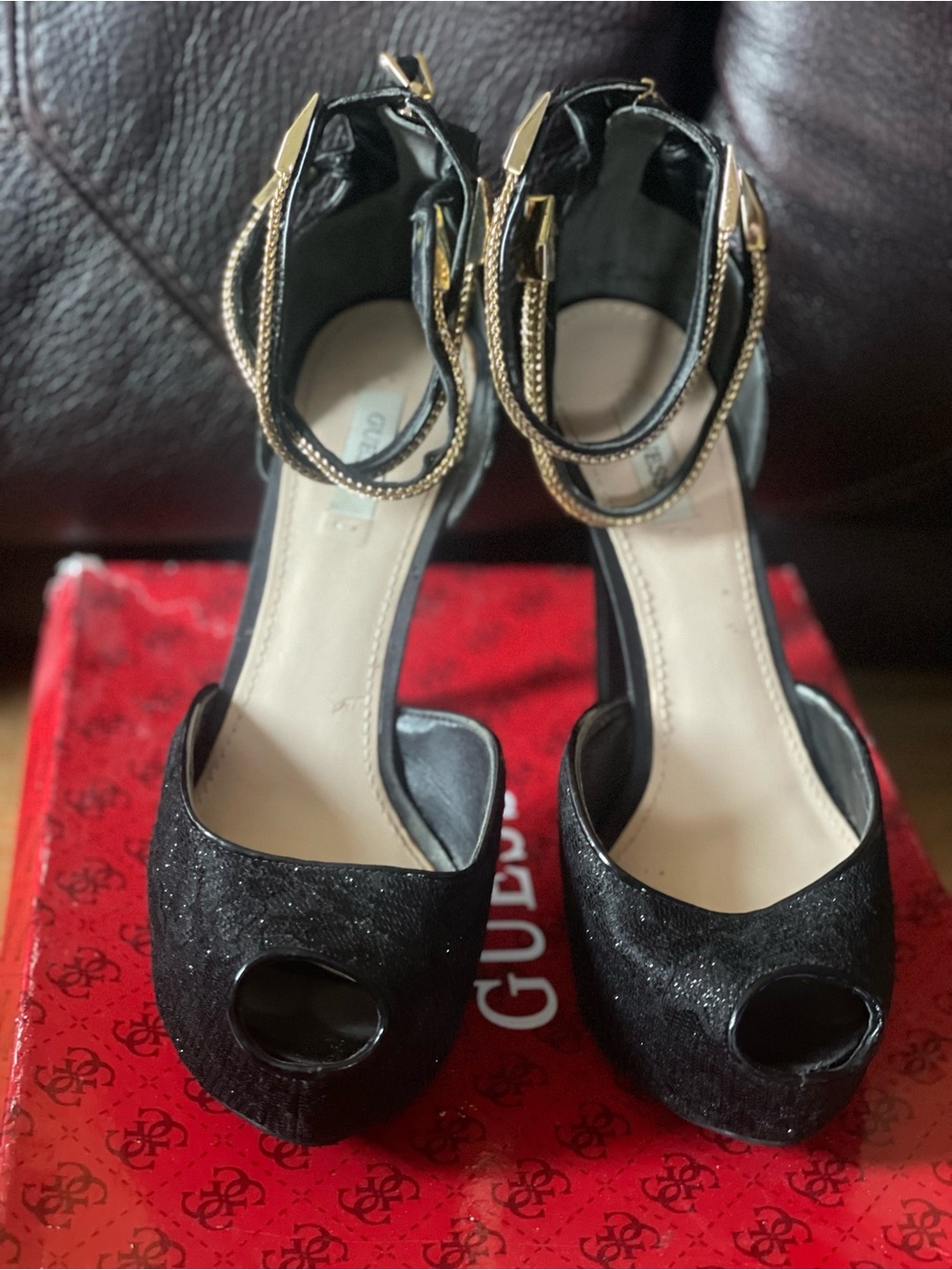 black peep-toe platform high heels by Guess featuring metallic gold double-wrap